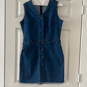 New knee length denim dress with button closure in front.